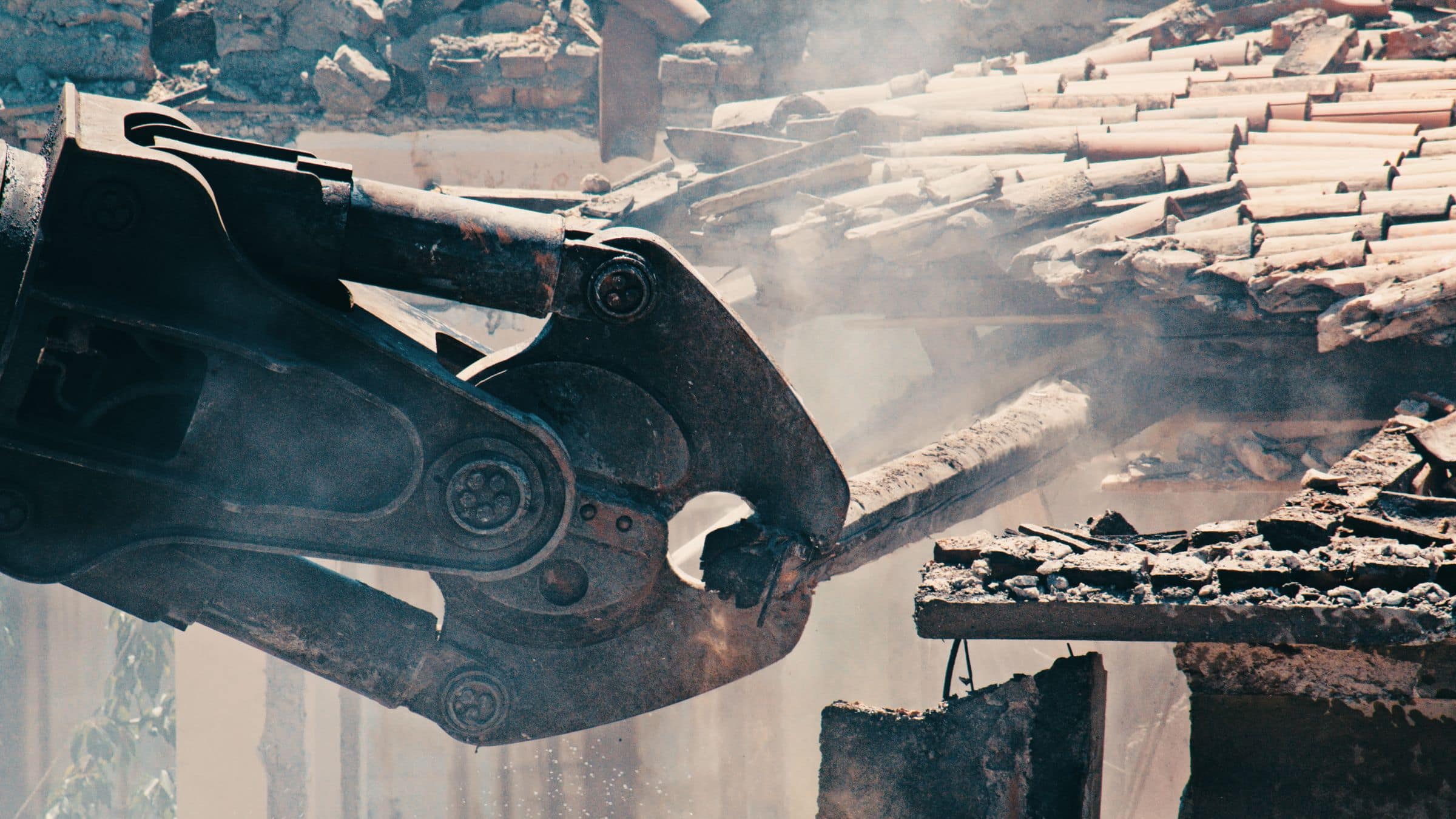 Demolition machinery clearing a structure on a jobsite